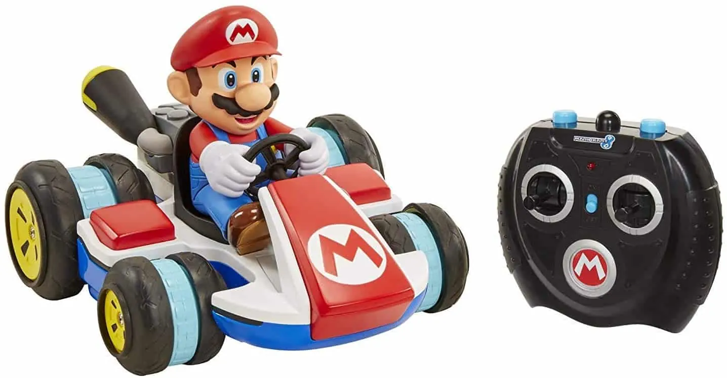 Mario Kart RC car with a Mario figure in a red kart next to its remote control