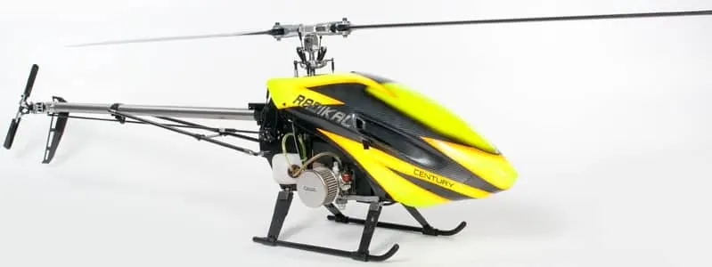 Yellow and black single-rotor RC helicopter with a fuel engine in its frame, on a white background