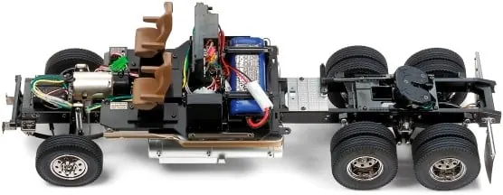 RC truck chassis without its body, showing the motor, electronics and battery