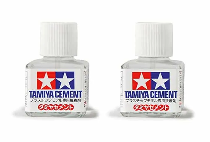 Two small square bottles of Tamiya Cement with white caps