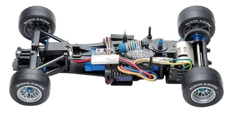 Assembled Tamiya F104 chassis without its body, showing the motor, electronics and Tamiya Racing tires