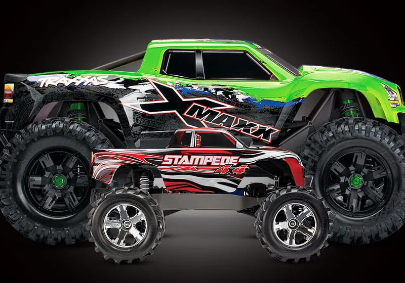 Green Traxxas X-Maxx next to a smaller Traxxas Stampede for size comparison