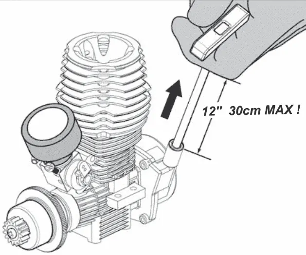 Diagram of a hand pulling a nitro engine's pull-start cord, with a 12 in (30 cm) maximum pull marked