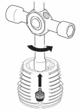 Diagram of a glow plug wrench removing the glow plug from the top of a nitro engine's cylinder head