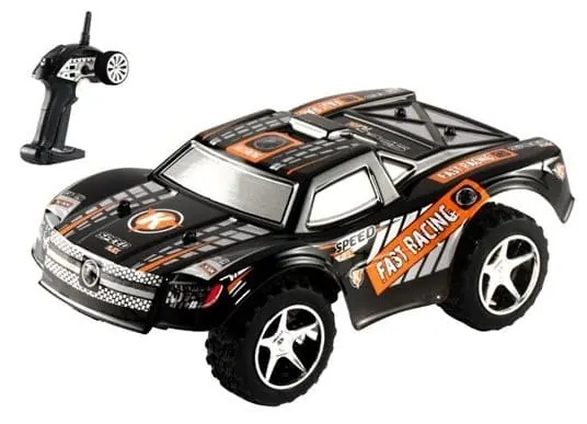 WLtoys L939 RC short course truck with a black and orange body next to its transmitter