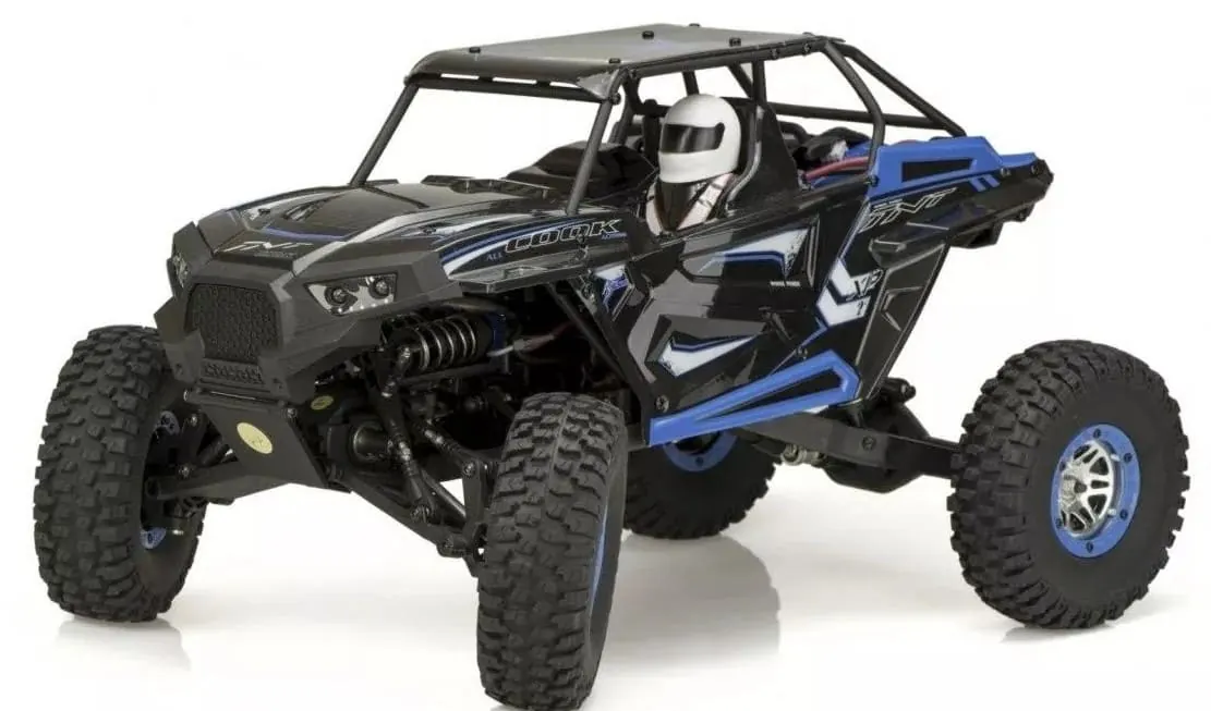 WLtoys 10428 RC rock crawler with a black side-by-side style body, roll cage and driver figure